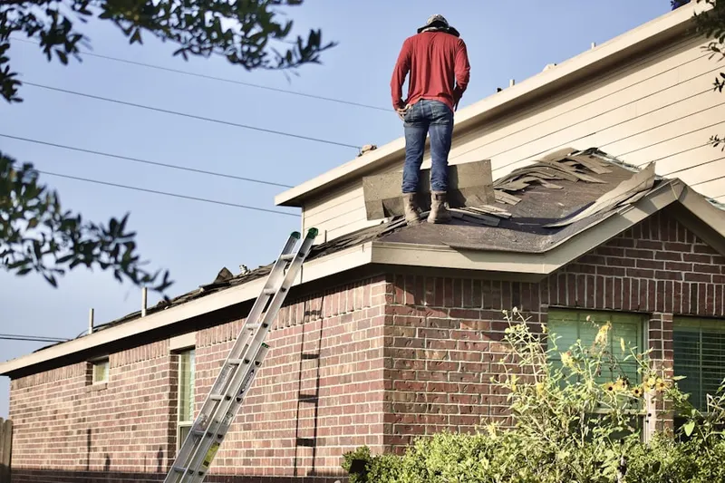 Professional roofer working on a residential roof in St. Pete Beach